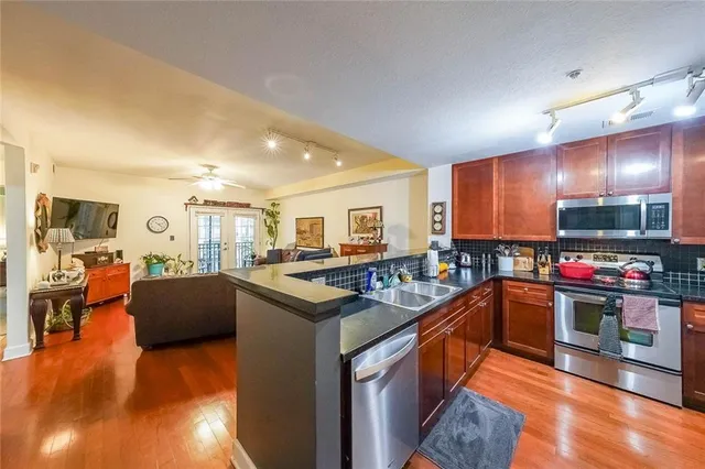 a kitchen with stainless steel appliances granite countertop a stove and a refrigerator
