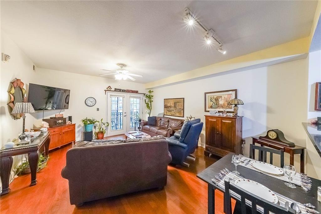 230 East Ponce De Leon Avenue, Unit 327 Decatur, GA 30030 - Photo 6 of 24 a living room with furniture and a flat screen tv