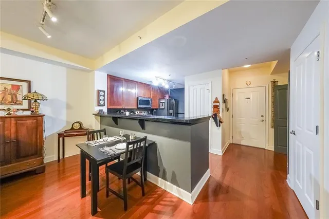 a kitchen with stainless steel appliances granite countertop a refrigerator and a stove top oven