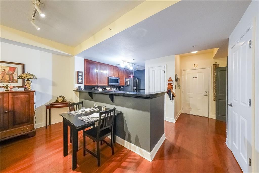 230 East Ponce De Leon Avenue, Unit 327 Decatur, GA 30030 - Photo 8 of 24 a kitchen with stainless steel appliances granite countertop a refrigerator and a stove top oven