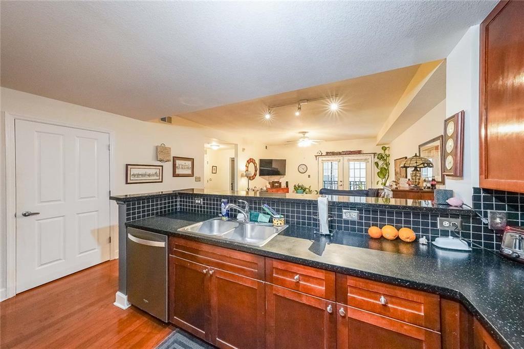 230 East Ponce De Leon Avenue, Unit 327 Decatur, GA 30030 - Photo 10 of 24 a kitchen with stainless steel appliances granite countertop a sink and a counter space