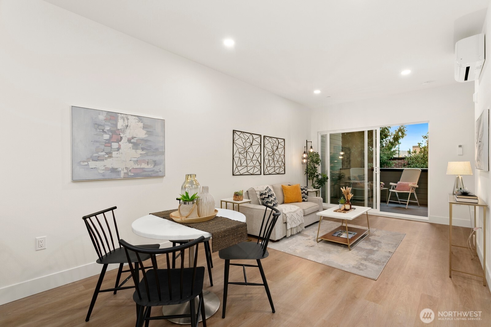 117 Wells Avenue South, Unit B Renton, WA 98057 - Photo 12 of 26 a dining room with furniture and wooden floor