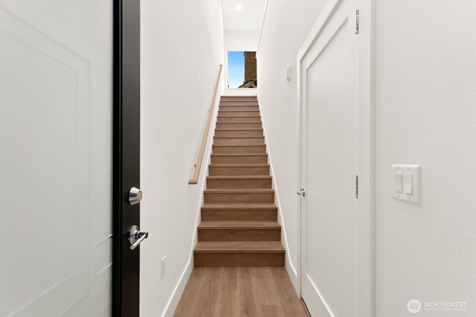 117 Wells Avenue South, Unit B Renton, WA 98057 - Photo 6 of 26 a view of a hallway with wooden floor and entryway
