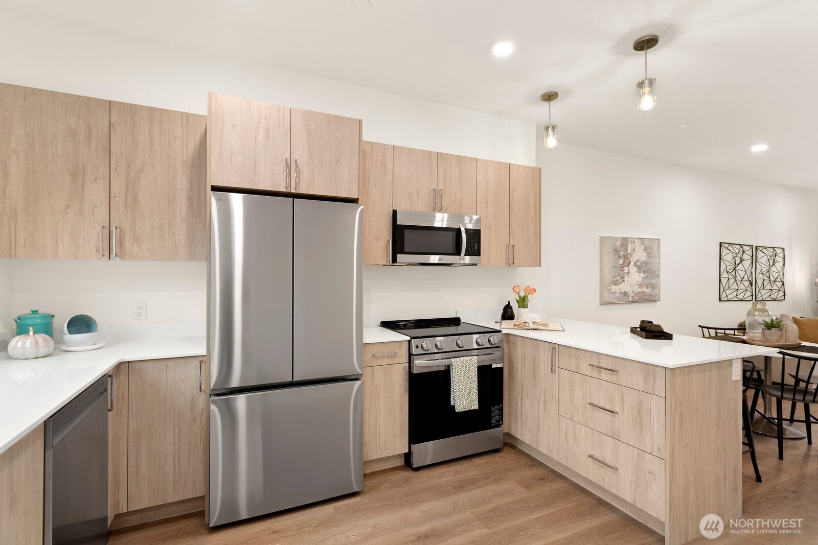 117 Wells Avenue South, Unit B Renton, WA 98057 - Photo 8 of 26 a kitchen with white cabinets and white appliances