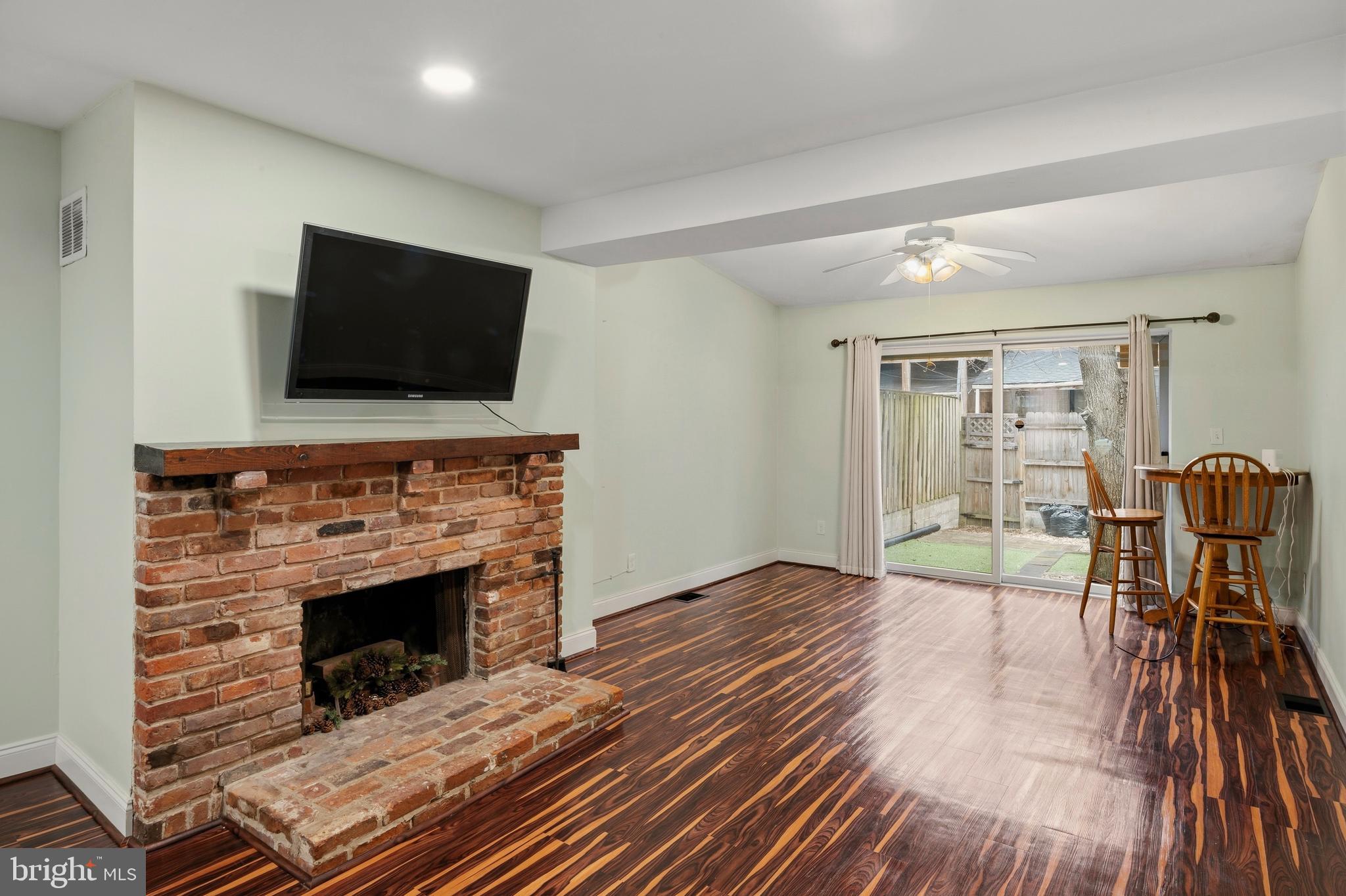 636 Portland Street Baltimore, MD 21230 - Photo 2 of 20 a living room with furniture a flat screen tv and a fireplace