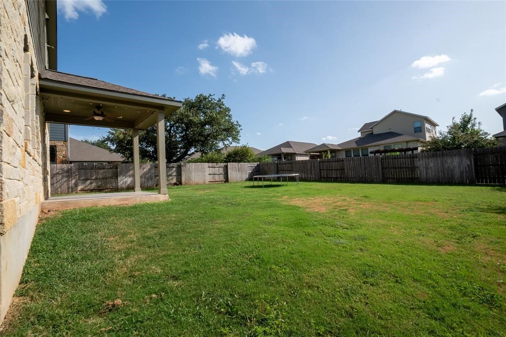 1333 Terrace View Drive Georgetown, TX 78628 - Photo 34 of 35 A spacious, enclosed backyard features a covered patio perfect for outdoor enjoyment.