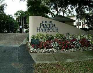 11000 Placida Road, Unit 1402 Placida, FL 33946 - Photo 1 of 1 a view of a sign in front of flowers