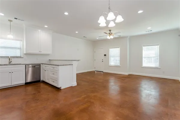 a kitchen with cabinets appliances a sink and a stove