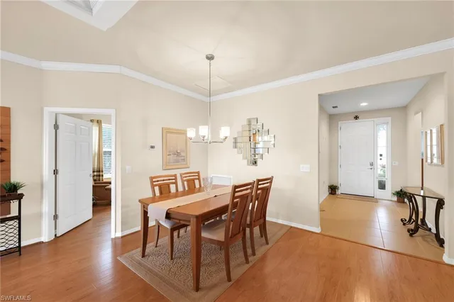 a view of a a dining room with furniture window and wooden floor