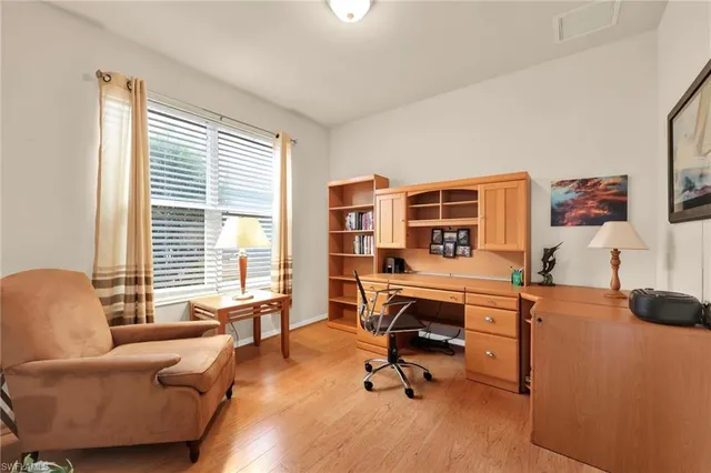 a view of a livingroom with workspace and a window