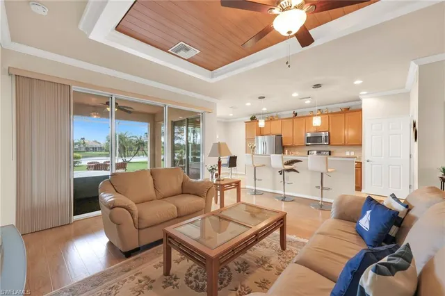 a living room with furniture and a large window with outer view
