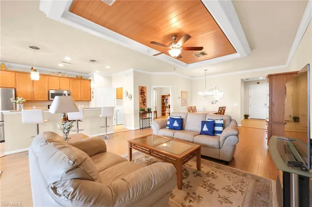 a living room with furniture a rug and a large window