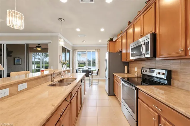 a kitchen with stainless steel appliances granite countertop a sink and stove