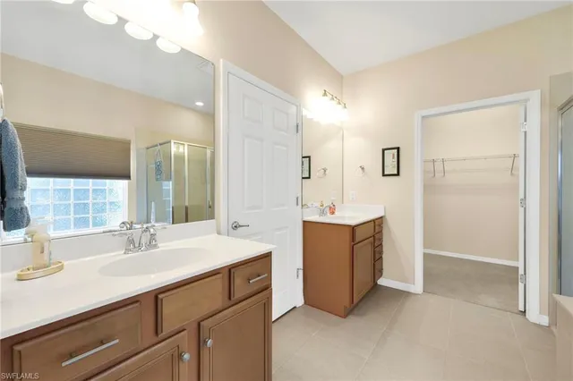 a bathroom with a sink double vanity and a mirror