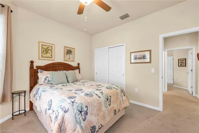 a bedroom with a bed and a ceiling fan