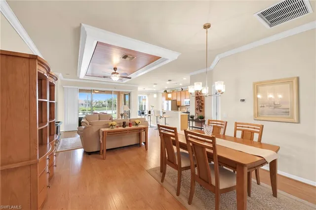 a dining room with furniture garden view and wooden floor