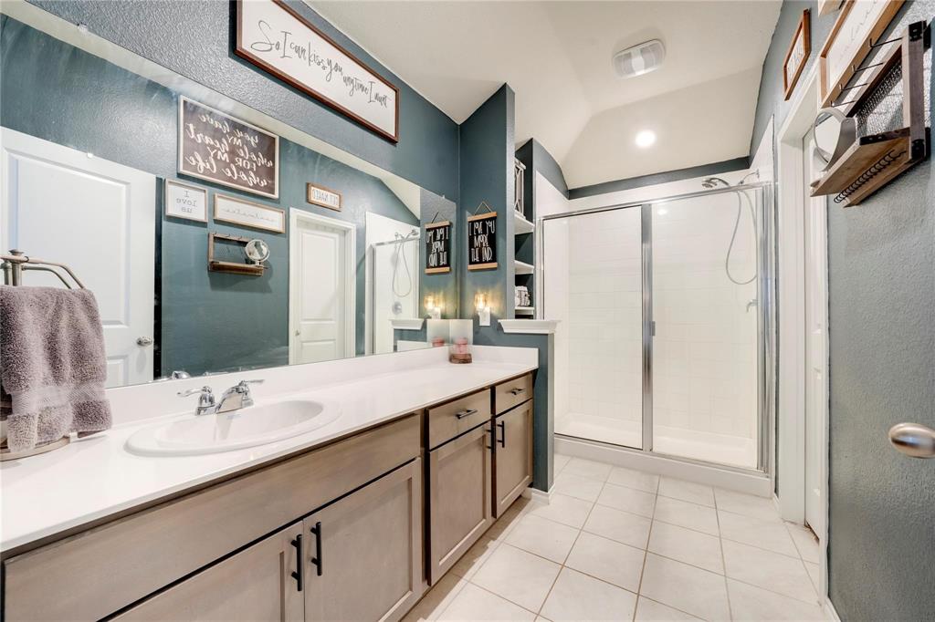 830 Rustic Way Josephine, TX 75189 - Photo 21 of 33 Bathroom with a shower stall, vanity, tile patterned flooring, and vaulted ceiling