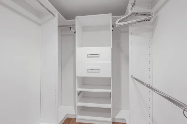 a bedroom with two beds and a large window