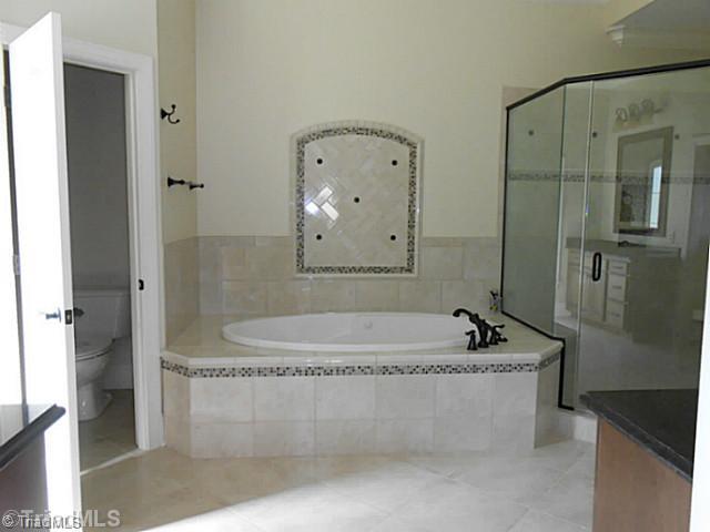 5808 Bison Drive Oak Ridge, NC 27310 - Photo 9 of 16 Master Bath/Spa. Jetted tub and separate shower in master bath.
