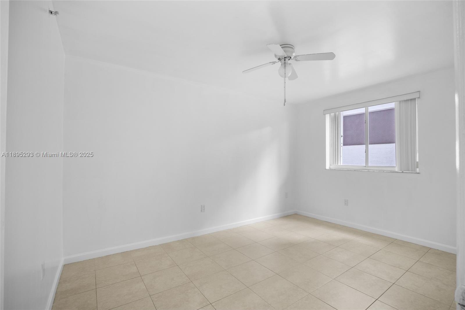 1060 Northwest 7th Street, Unit 106 Miami, FL 33136 - Photo 17 of 26 a view of a room with a ceiling fan and a window