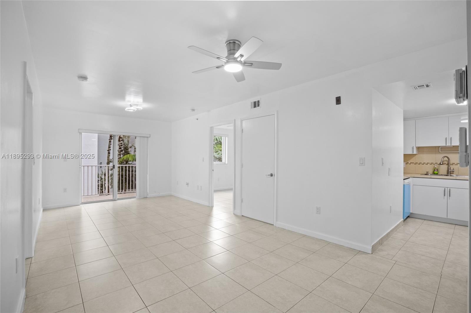 1060 Northwest 7th Street, Unit 106 Miami, FL 33136 - Photo 9 of 26 a view of an empty room with a kitchen