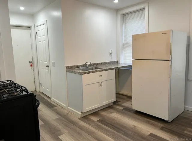a kitchen with a refrigerator and a stove