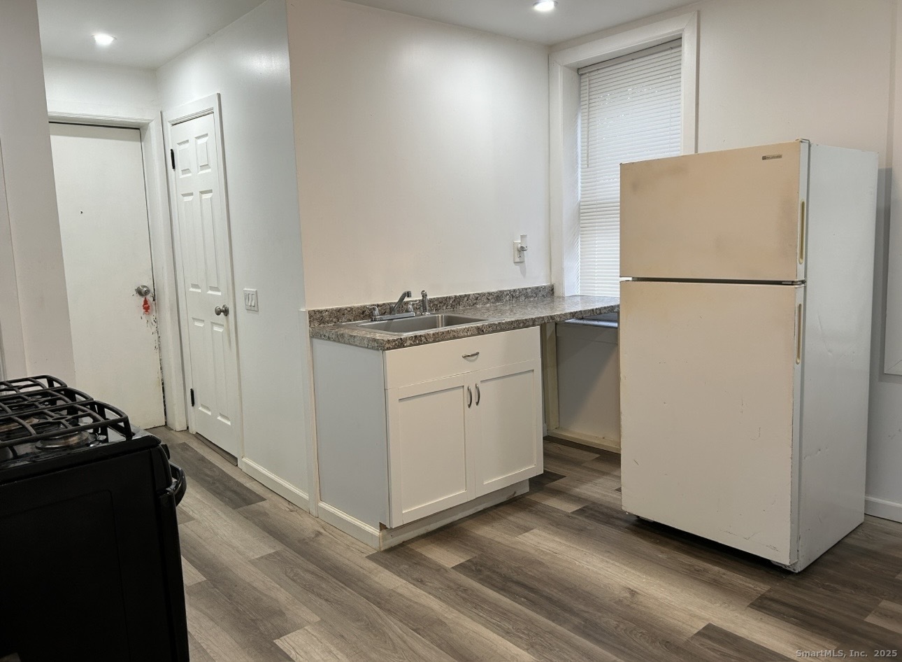 a kitchen with a refrigerator and a stove