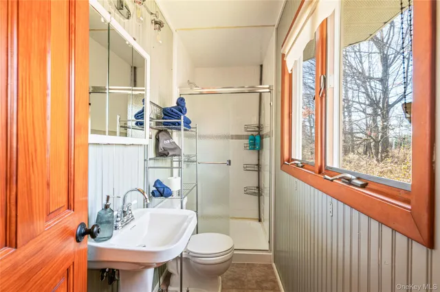 a bathroom with a sink toilet and a mirror