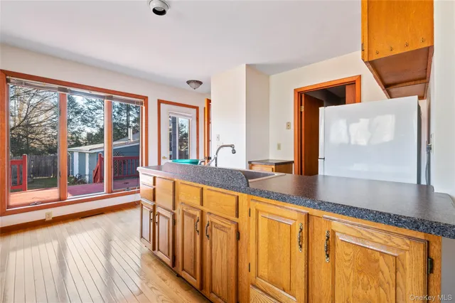 a view of front door and hallway with wooden floor