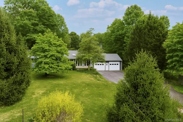 a view of a big yard with large trees