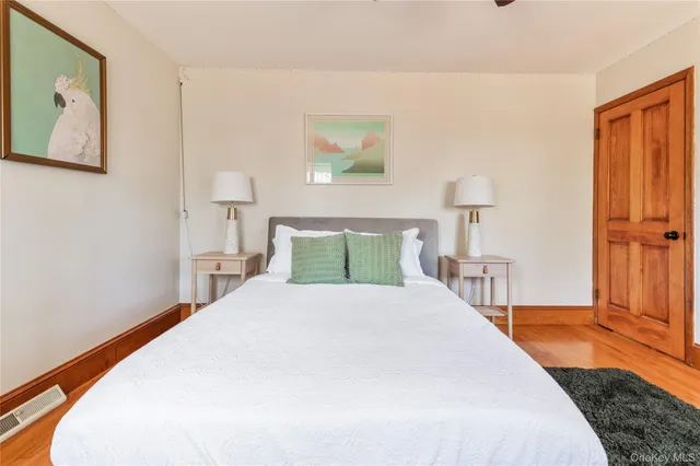 a bedroom with a bed and a night stand