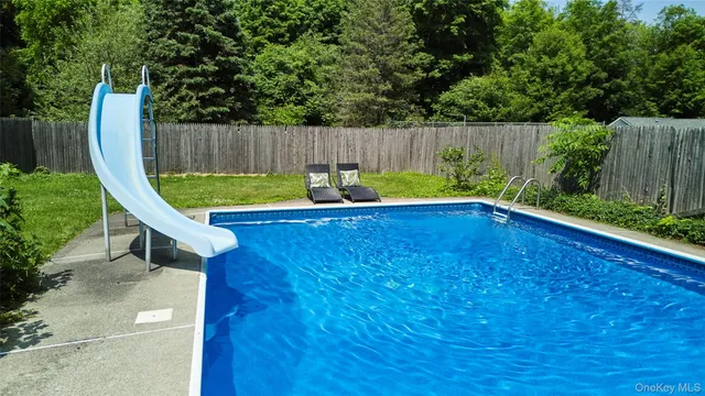 a view of a swimming pool with a sitting area