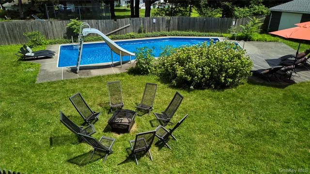 a view of a backyard with sitting area