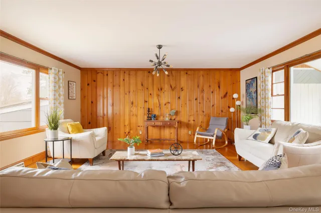 a living room with furniture and large window