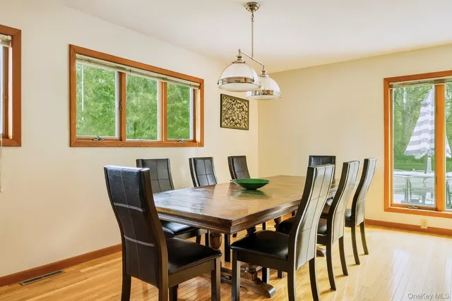 a view of a dining room with furniture window and outside view