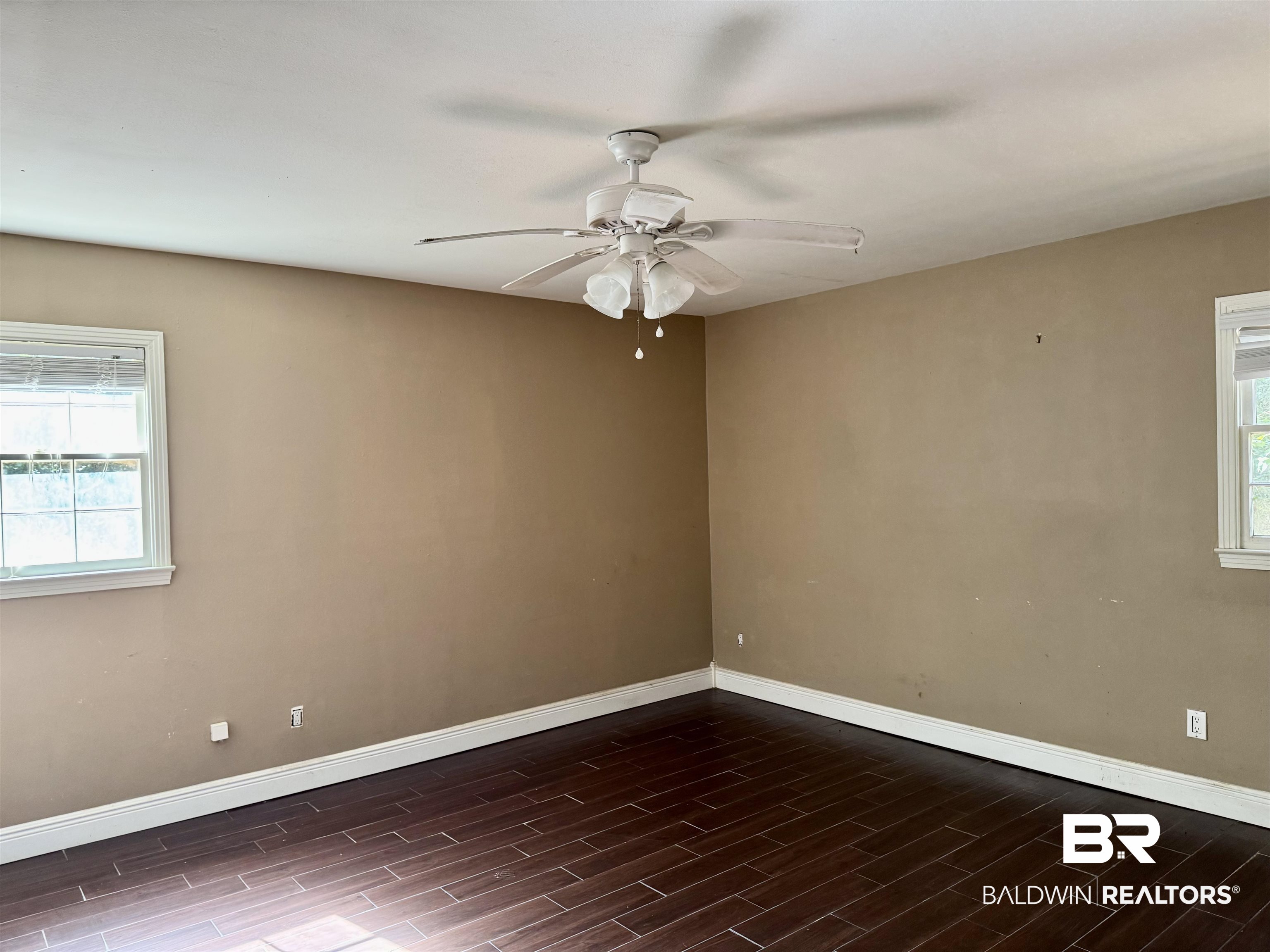 287 Wingfield Drive Mobile, AL 36607 - Photo 11 of 24 Empty room with plenty of natural light, baseboards, and wood finished floors
