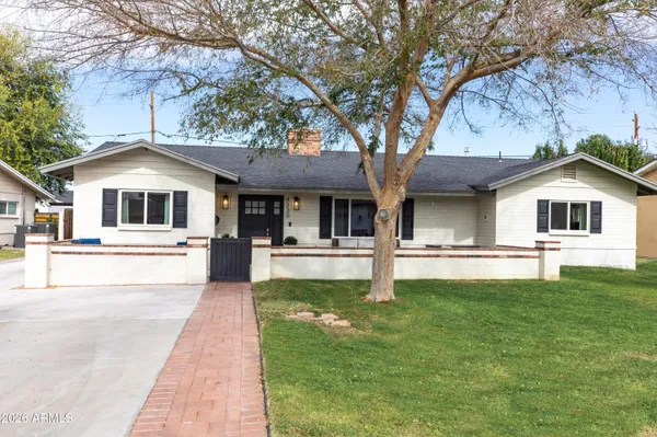a front view of a house with a garden