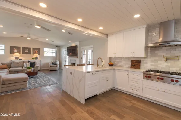 a large white kitchen with cabinets
