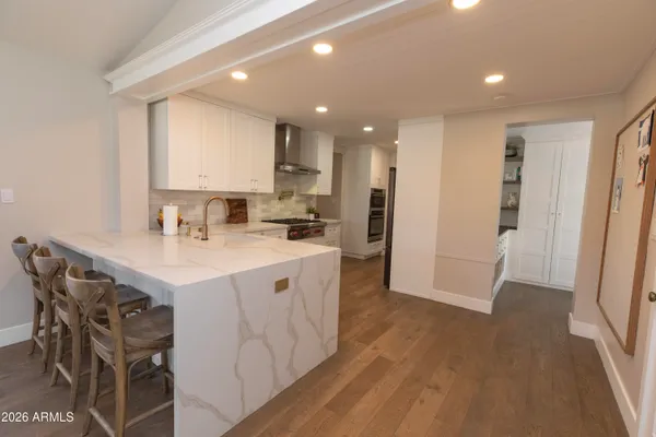 a kitchen with a sink appliances and cabinets