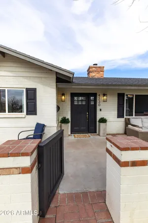 a kitchen view with a sink and large window