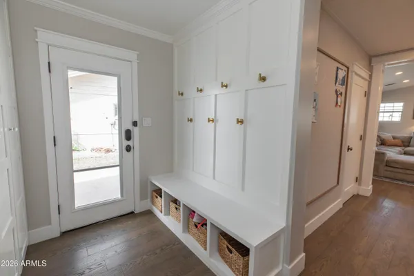 a view of an entryway with wooden floor