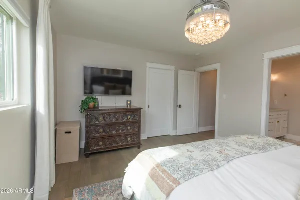 a bedroom with a bed and a television