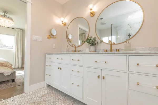 a bathroom with a double vanity sink and a mirror