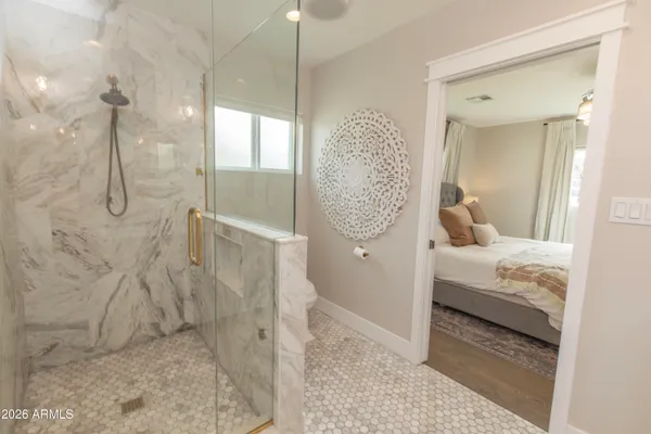 a bathroom with a granite countertop shower a sink and a mirror