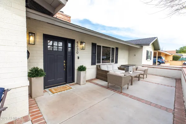 a view of a patio with couches and potted plants