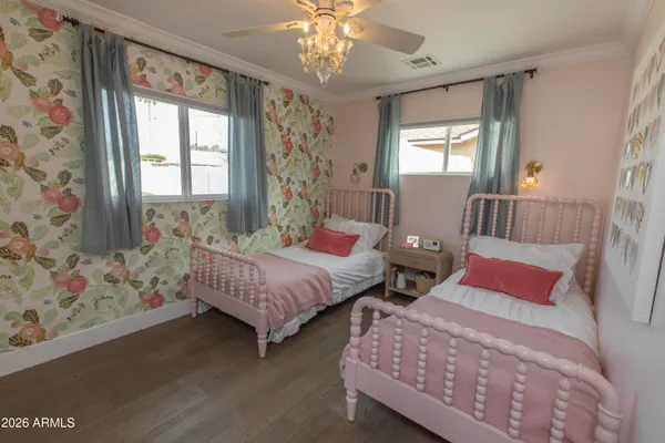 a bedroom with two beds and a window