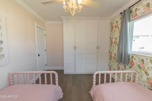 a bedroom with a bed and a window