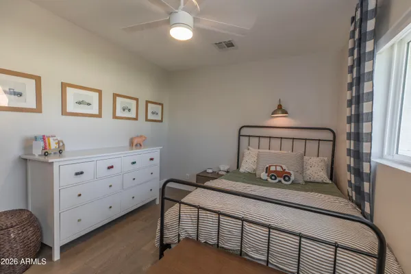 a bedroom with furniture and a baby crib
