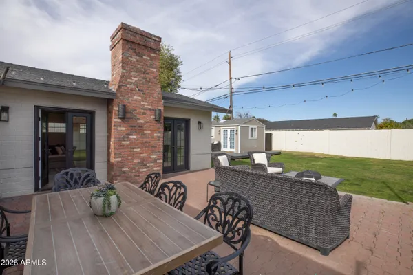 a view of a patio with table and chairs potted plants with wooden floor