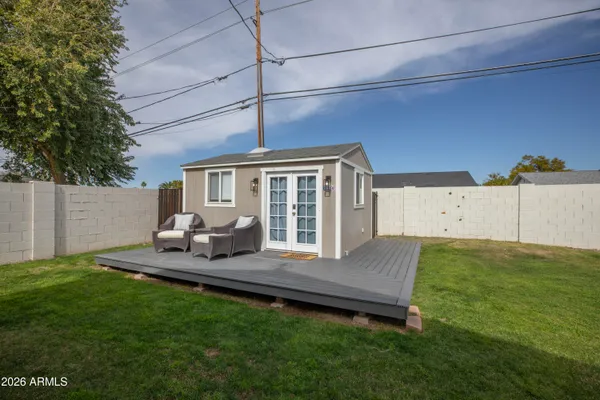 a view of a house with backyard sitting area and garden